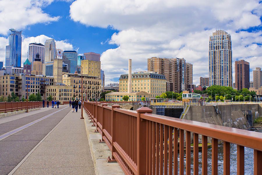 Minneapolis, MN - Minneapolis Skyline View From Across a Bridge with City, Clouds and Blue Sky in the Background